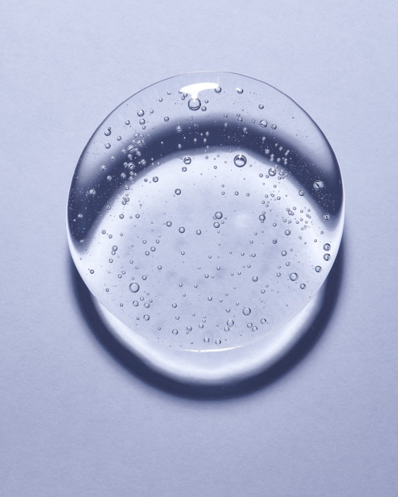 Single blob of glycerin on pale blue background