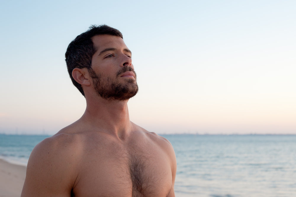 Your ultimate guide to looking younger: handsome young man on the beach