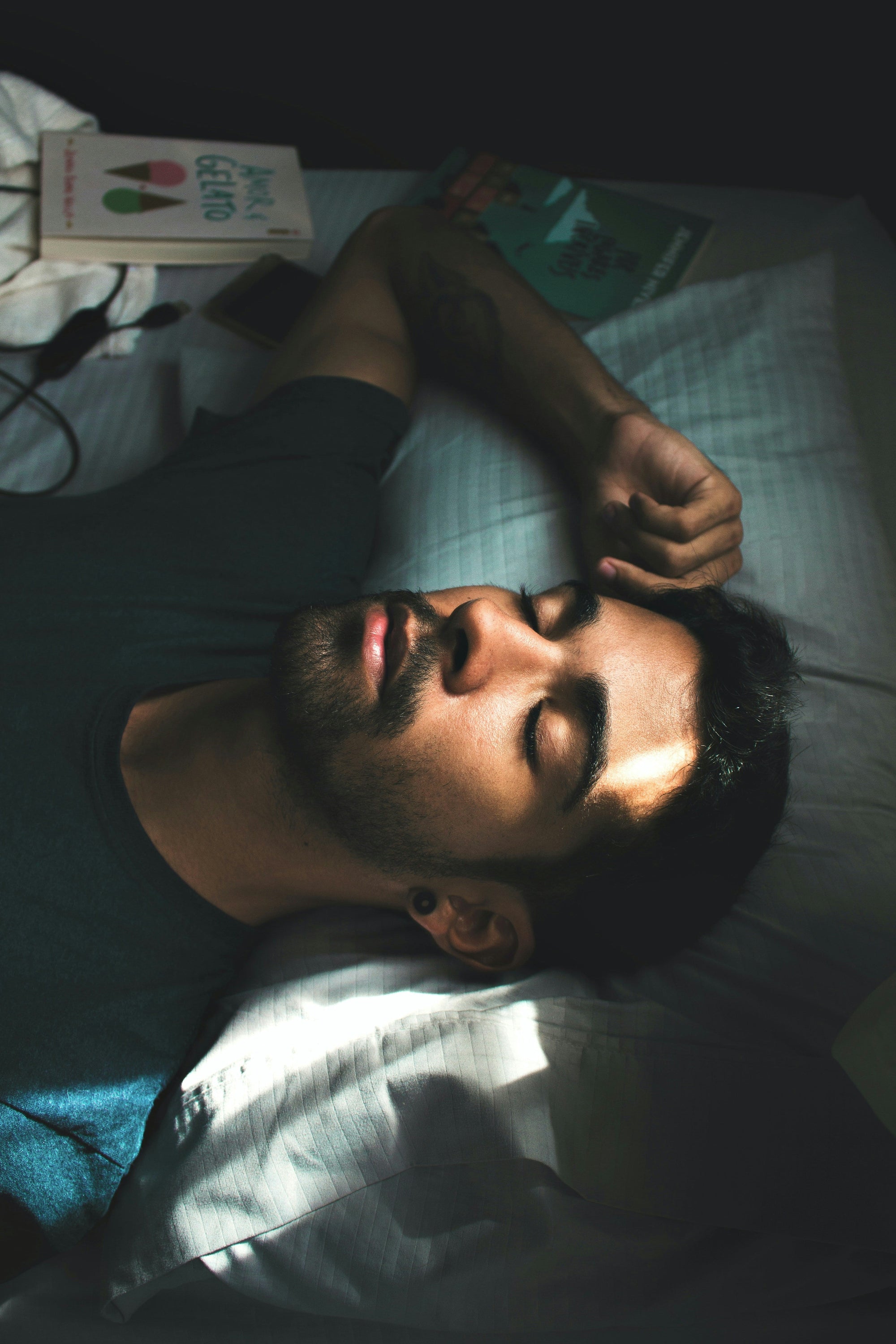 Melatonin For Better Sleep, Less Stress… And Great Skin! Close up of handsome man sleeping