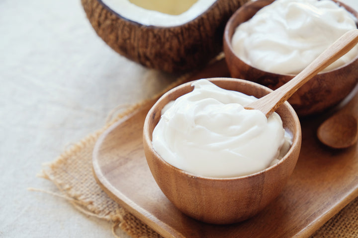 Probiotics for Youthful, Glowing Skin. Creamy organic yoghurt in wooden bowl