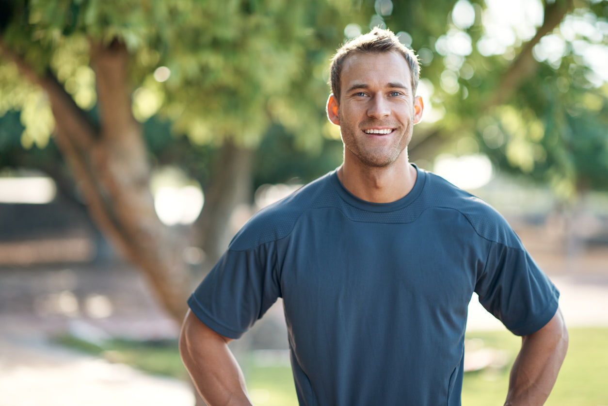 Why Do I Need a Multivitamin if I Already Have a Balanced Diet? Fit healthy man  standing outside in sunshine