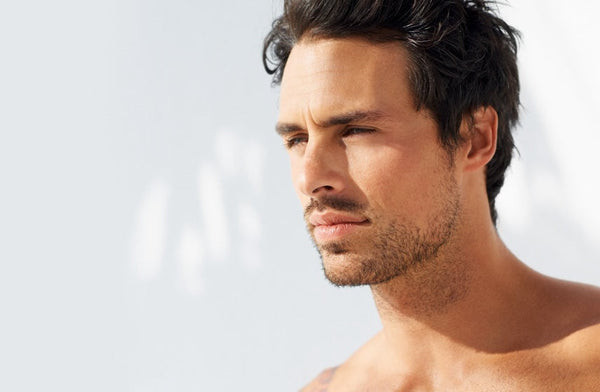Peptides for Men’s Skin: How To Rebuild Your Collagen . Handsome man in profile on white background