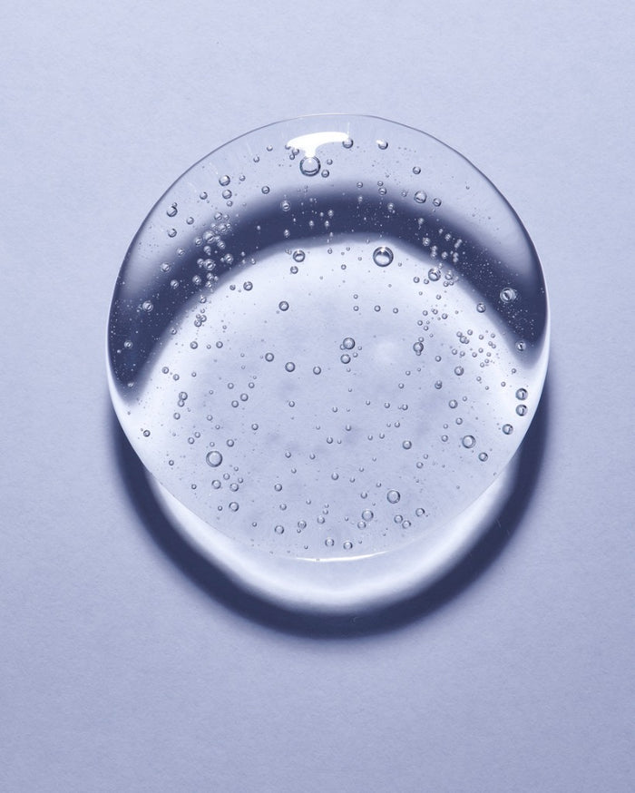 Single blob of glycerin on pale blue background