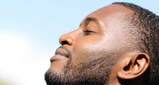 Hyperpigmentation in Men: What Actually Works. Close up side view of handsome black man with glowing clear skin