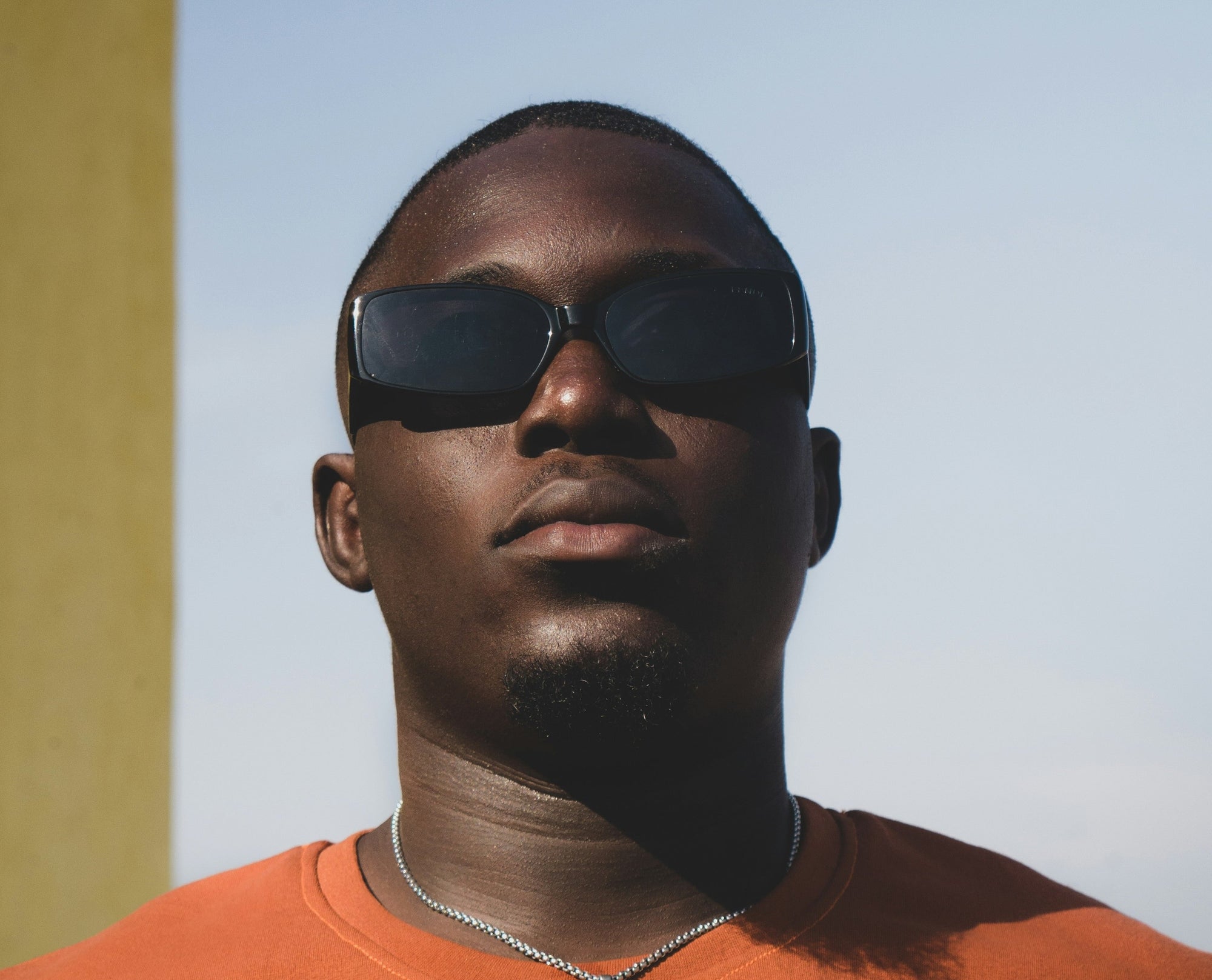 Dealing with Dryness: How Black Men Can Keep Skin Hydrated and Healthy. Close up of handsome black man with glowing, healthy skin