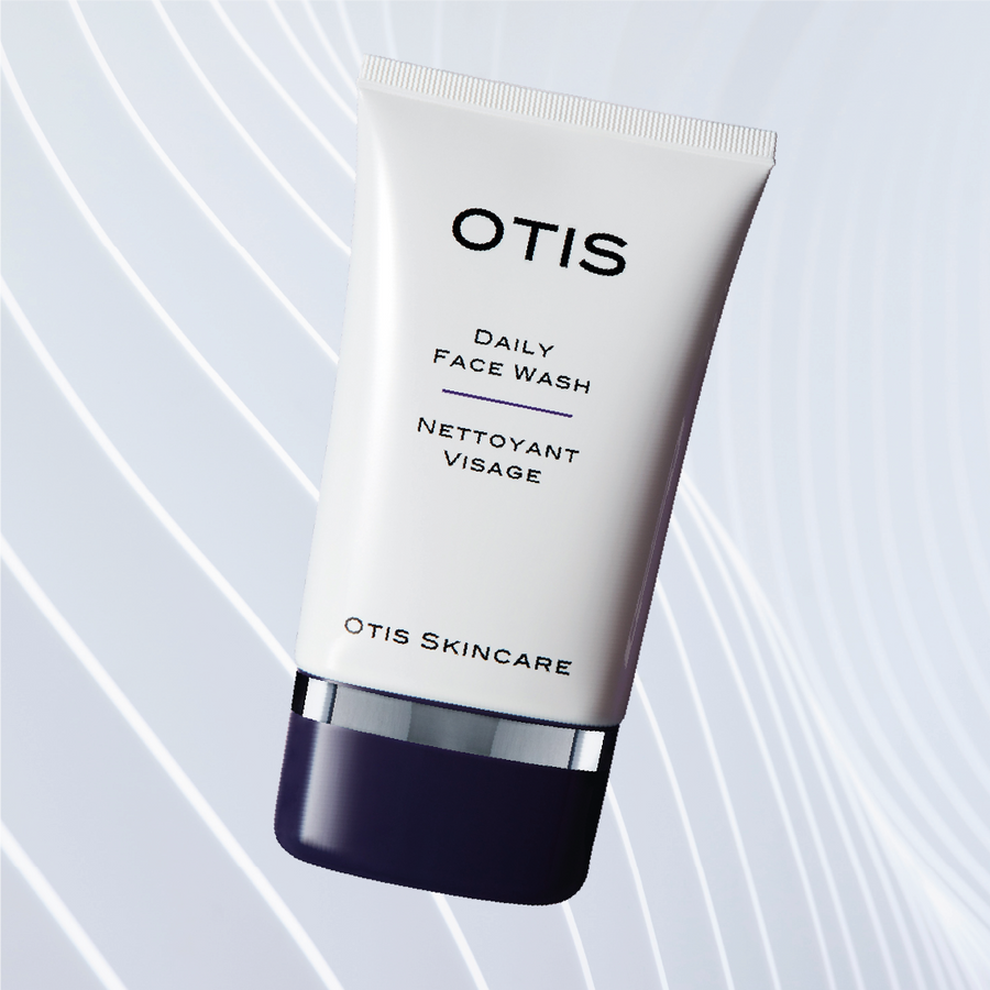 Tube of OTIS Daily Face Wash on white wavy textured background