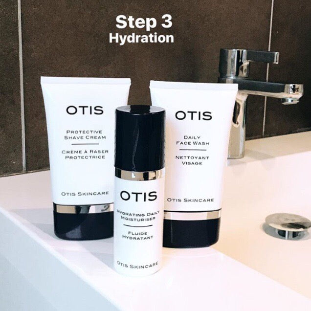 OTIS Hydrating Daily Moisturizer with other OTIS products against charcoal gray tiles